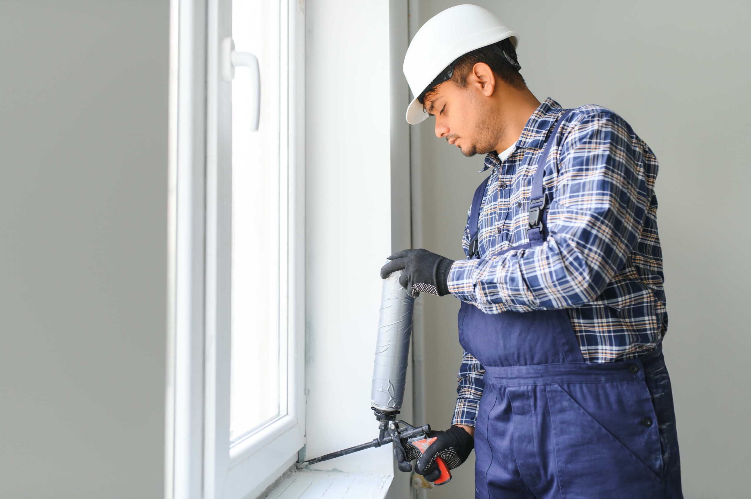 indian-worker-using-a-silicone-tube-for-repairing-2026-01-09-06-50-06-utc (1)